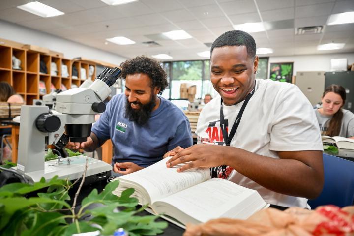 Students looking at a botany book